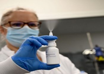 A laboratory worker tests a nasal spray at the Pharma and Beauty factory in Saint-Chamas, southeastern France, on January 21, 2021. - The Pharma and Beauty company has developped a nasal spray based on ionised water, known for its antimicrobial properties, which eliminates 99% of the viral load. (Photo by NICOLAS TUCAT / AFP) (Photo by NICOLAS TUCAT/AFP via Getty Images)