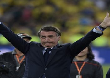 Brazilian President Jair Bolsonaro waves at the crowd after Brazil won the Copa America football tournament by defeating Peru in the final match at Maracana Stadium in Rio de Janeiro, Brazil, on July 7, 2019. (Photo by Juan MABROMATA / AFP)
